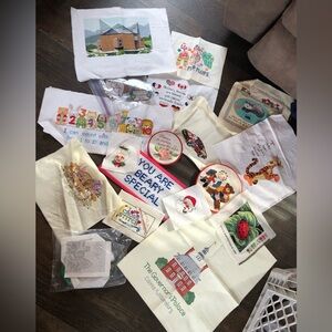 Lot of 18 finished cross stitch pieces.